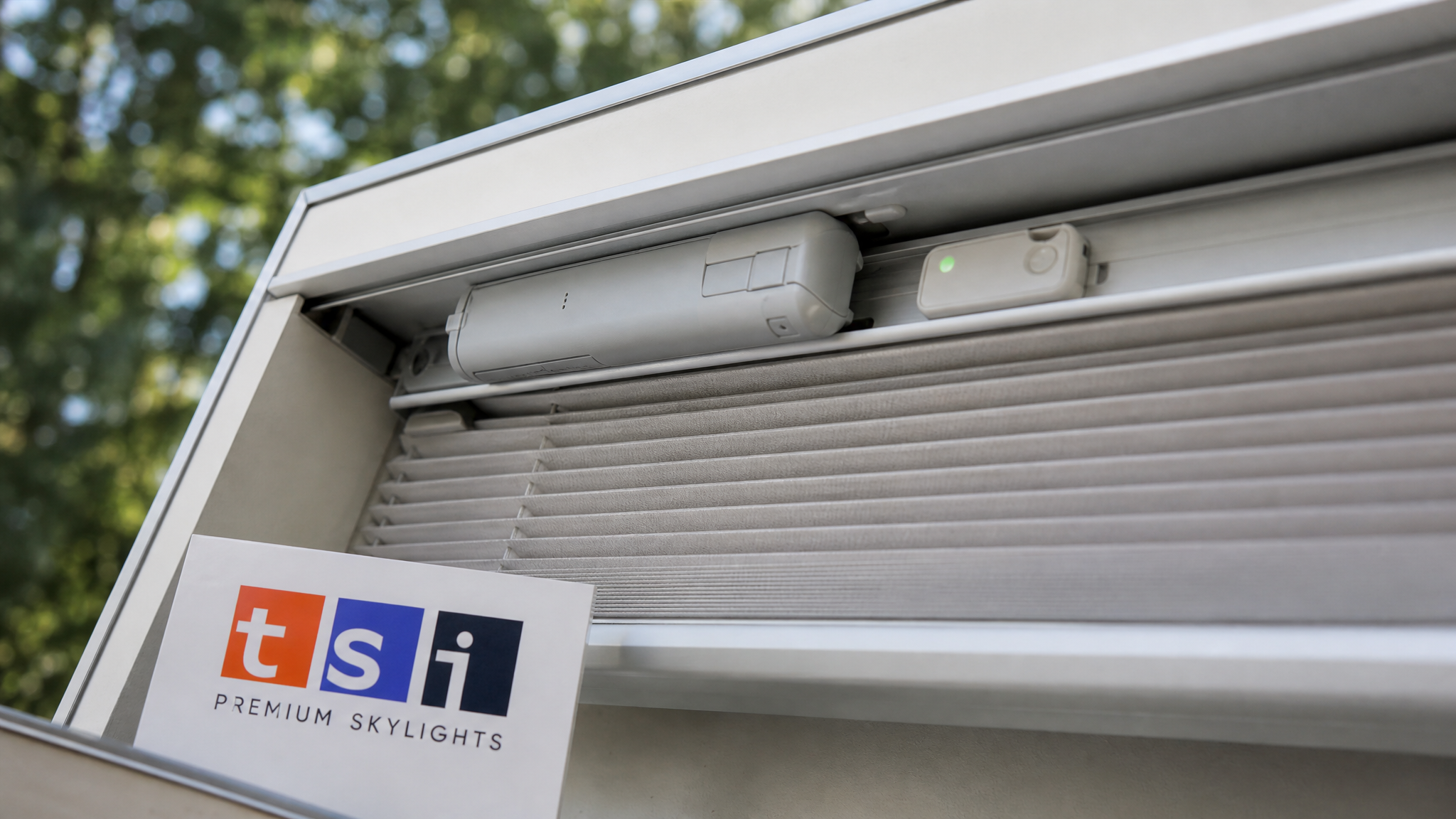 Close-up of a motorized skylight blind motor and smart home bridge sensor